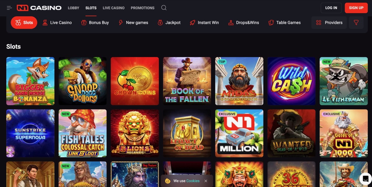 N1 Casino slots lobby displaying popular titles including Book of the Fallen, Bonanza, Wild Cash, and Wanted across a dark-themed grid layout